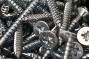 a bunch of screws and nuts in a pile