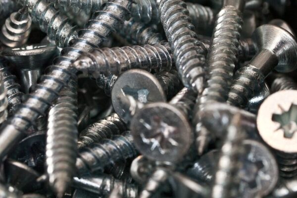 a bunch of screws and nuts in a pile
