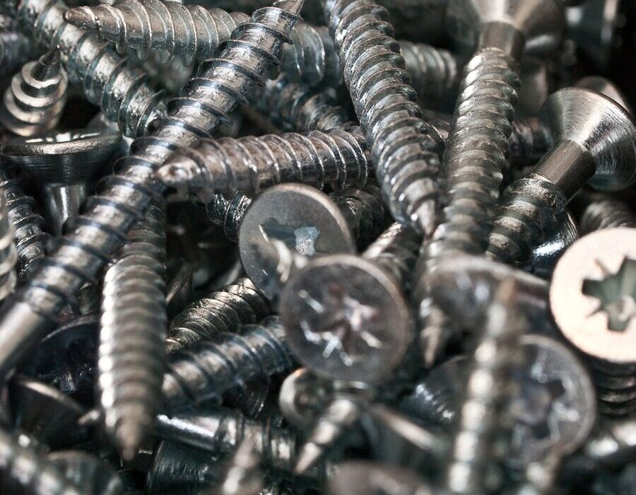 a bunch of screws and nuts in a pile